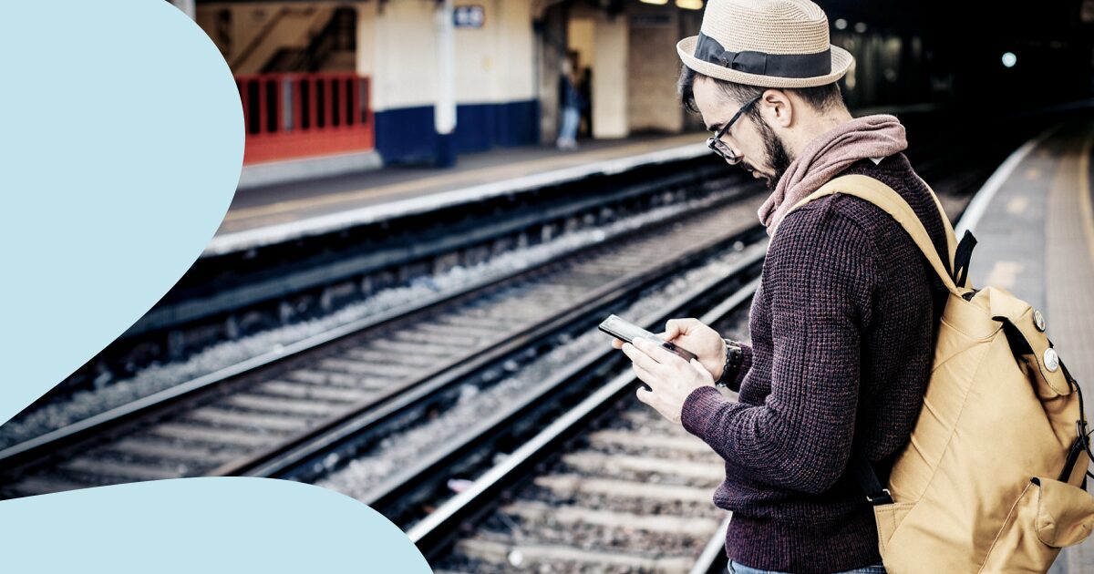 Freelancer saving travel expenses on train platform