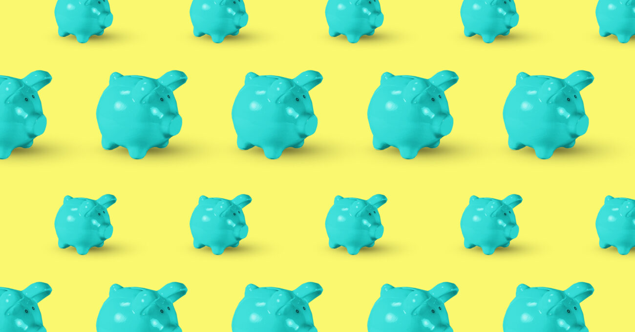 Turquoise piggy banks on yellow background