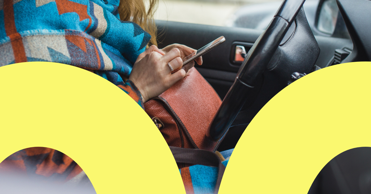 Woman recording mileage in car